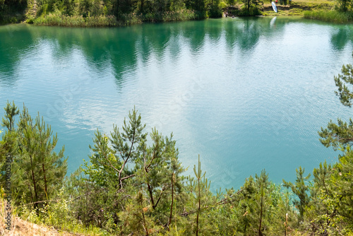 beautiful summer nature, turquoise lake surrounded by pine trees