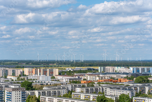 Canvas Print An urban residential area stretches to the horizon, where numerous wind turbines generate energy