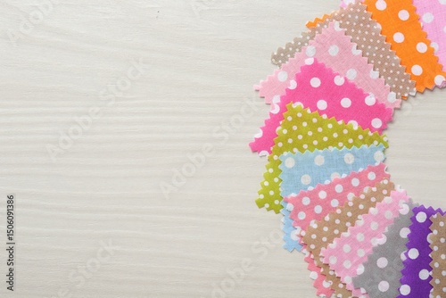 Samples of different fabrics on white wooden table, flat lay. Space for text