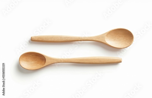 Two wooden spoons on white background. Kitchen utensils, eco-friendly, natural materials, handmade. Cooking, culinary, food preparation tools for home cooking, restaurants.