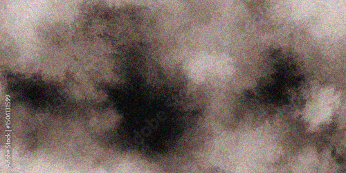 Abstract background with dark and light spots creating a textured and grainy visual effect.