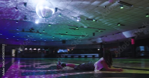 Young woman preparing to do trick on roller skates then splatting on ground and making cute pose - steady cam shot