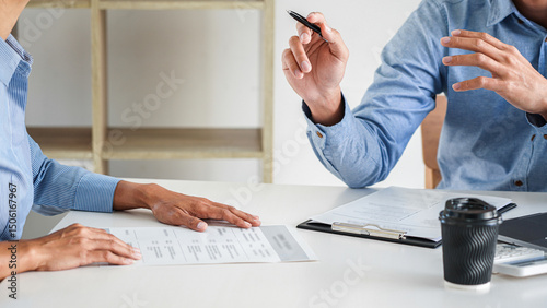 Interviewer or Board reading a resume during job interview, Employer interviewing a young male job seeker for recruitment talking in modern office and filing card, employment and recruitment concept
