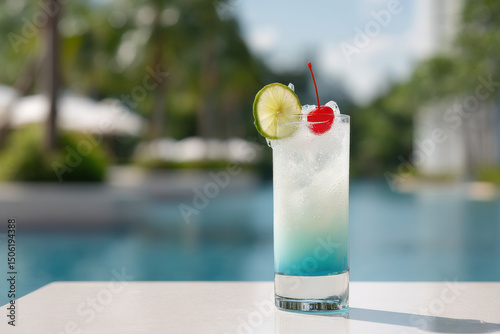 refreshing iceberg cocktail served in tall glass placed on pristine white table beside sparkling pool