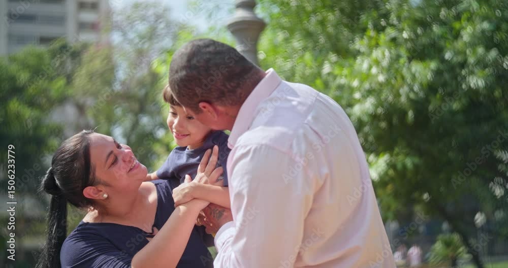 Father kissing his son on a fun family outing outdoors on a sunny day. Father kissing his son on a fun family outing outdoors on a sunny day.