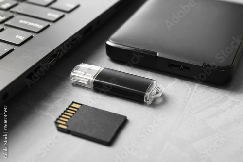 Wallpaper Mural Flash drive, SD memory card, external hard disk and laptop on gray textured table, closeup Torontodigital.ca