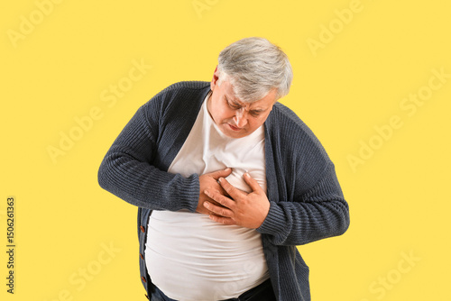 Senior man having heart att...