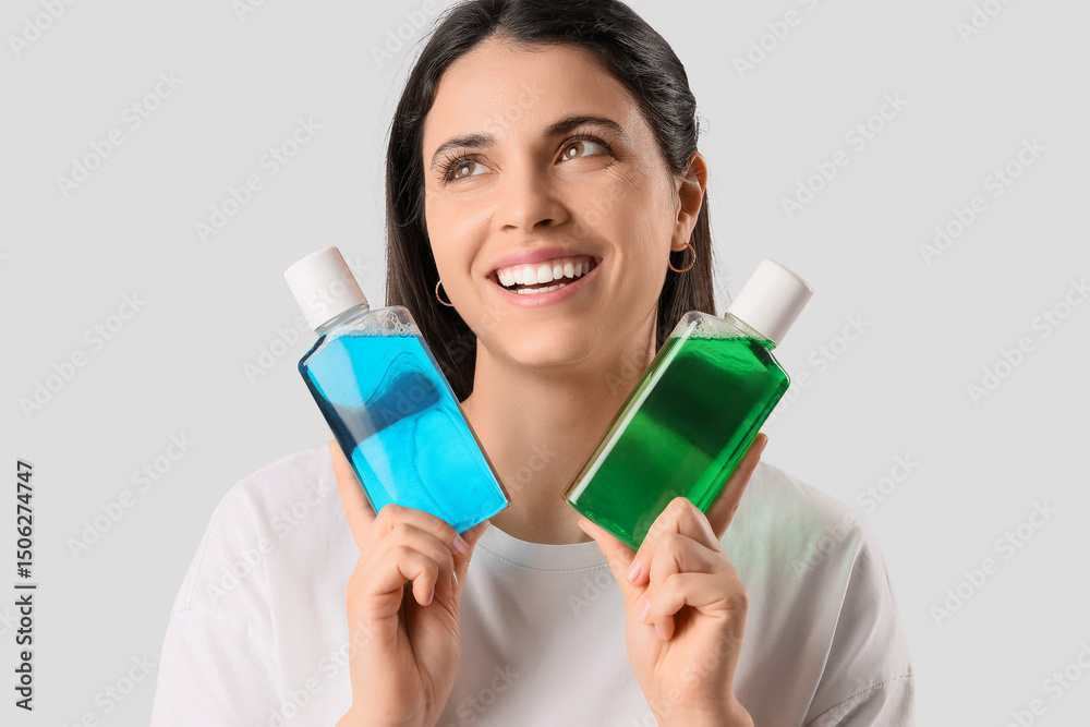 Young woman with healthy teeth and mouth rinse on light background, closeup Young woman with healthy teeth and mouth rinse on light background, closeup