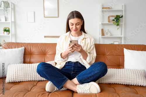 Beautiful young woman using...