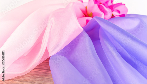 Pastel Fabric Drape: Soft, delicate pastel fabrics in shades of pink and purple create a luxurious and elegant drape, showcasing the textures and flow of the materials.