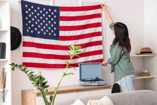 Young woman hanging USA fla...