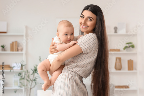 Happy mother holding her li...