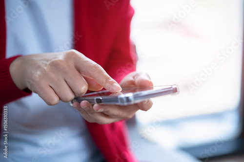 A woman playing with a mobile phone