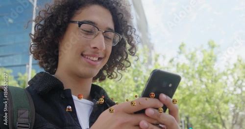 Man tapping phone screen during social media use and generating emojis around device on sidewalk