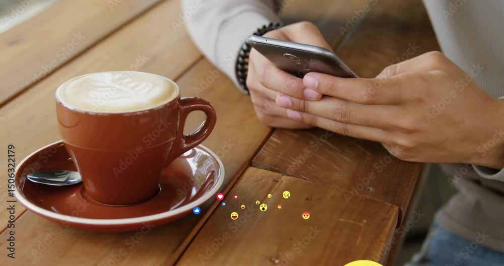 Picking up smartphone, man's hands scrolling emojis over café table showing technology feedback