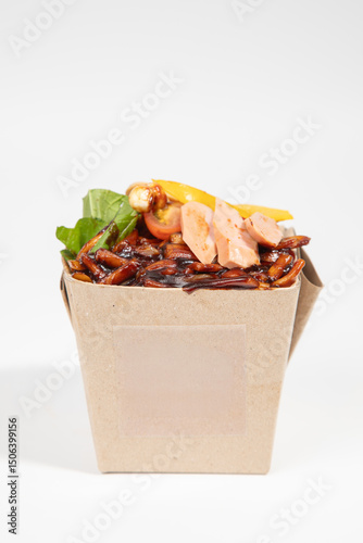 Delicious Asian noodles with fresh ingredients in an eco-friendly takeaway box. isolated on white background