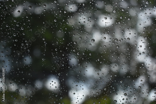 Fotografi water drop on mirror in rainy day, blur natural background