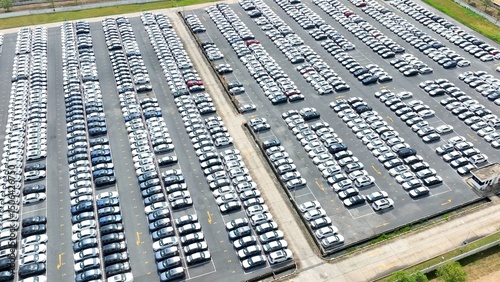 The aerial view illustrates a fleet deployment center, where vehicles are strategically parked and prepared for distribution to customers, rental services, or dealerships across a large area.