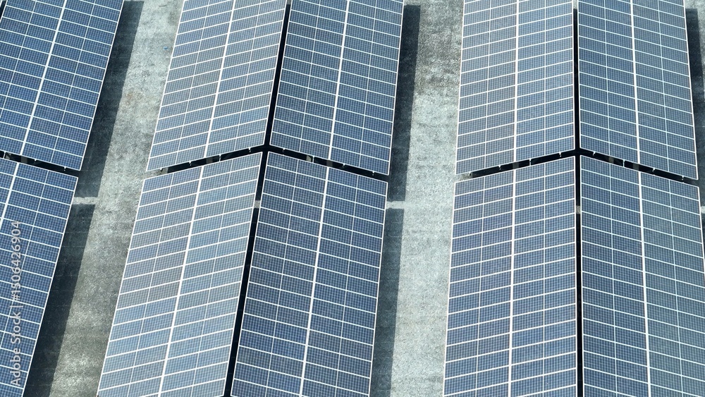 Obraz premium An aerial perspective shows the scale of a solar farm, where vast panels are strategically placed to maximize sunlight capture, marking a significant step toward renewable energy dominance. 
