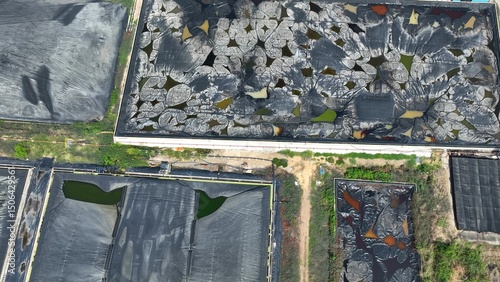 Fotografi Contrasting ponds highlight the difference between degraded waste zones with chemical exposure and a newly lined, well-maintained containment cell