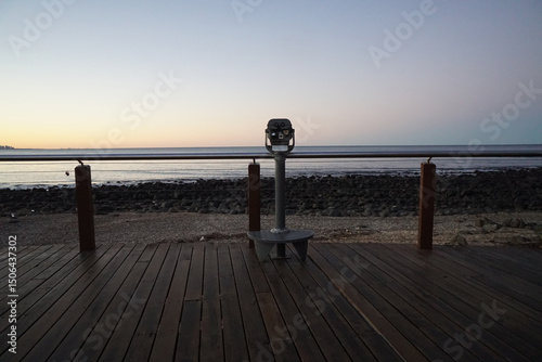 Binoculars look out over beach sunset