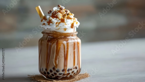 Caramel-drizzled bubble tea with whipped cream and tapioca pearls, served in a jar for a sweet look.