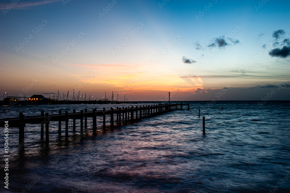 Fishing pier at sunset in Fairhope , Alabama with dramatic clouds. Fishing pier at sunset in Fairhope , Alabama with dramatic clouds.
