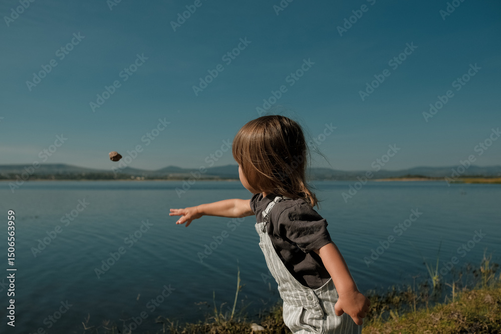 Toddler Boy Throwing Rock into Lake in Mexico Toddler Boy Throwing Rock into Lake in Mexico