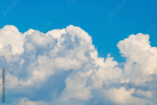 Fluffy white clouds against clear blue sky on a sunny day