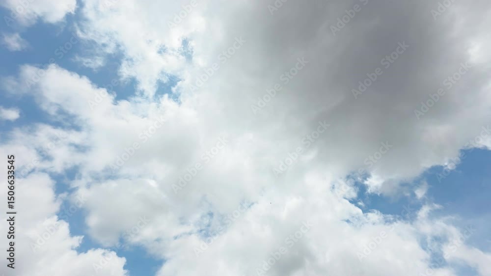 Time-lapse or timelapse of fluffy clouds drifting across a clear blue sky on a sunny day. Bright and peaceful weather scene, White clouds move quickly across a vibrant blue sky in fast motion Time-lapse or timelapse of fluffy clouds drifting across a clear blue sky on a sunny day. Bright and peaceful weather scene, White clouds move quickly across a vibrant blue sky in fast motion