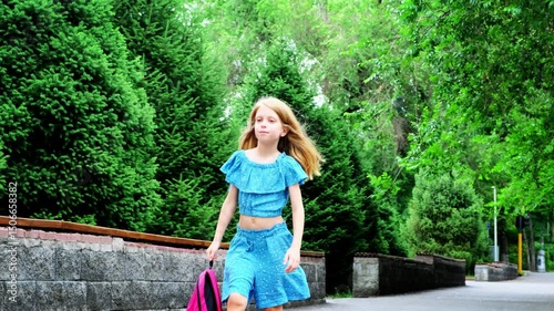 Wallpaper Mural A nine-year-old girl walks down the street with a backpack in her hand. Torontodigital.ca