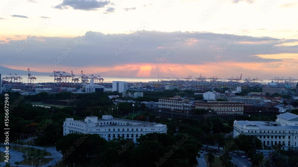 Urban aerial view overlooking historical Intramuros walled city during sunset in capital city of Manila Philippines Urban aerial view overlooking historical Intramuros walled city during sunset in capital city of Manila Philippines