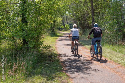 Fotografie Adult couple taking a bike ride through Landes, Aquitaine Region