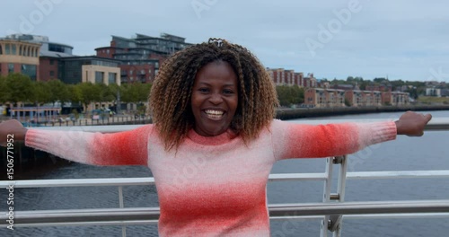 Cheerful Woman Laughing on a Bridge