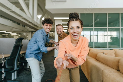 Ambitious business people participating in tug-of-war contest photo