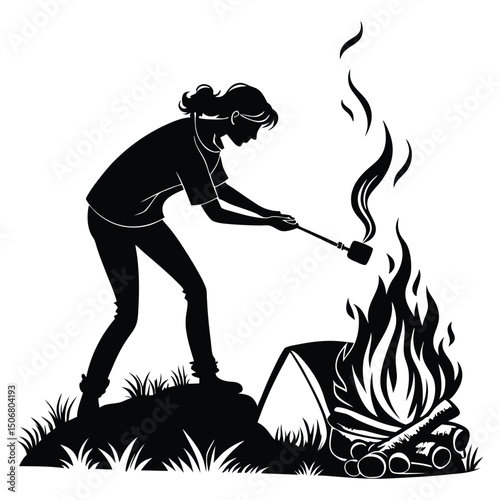 woman lighting fire at campsite black silhouette