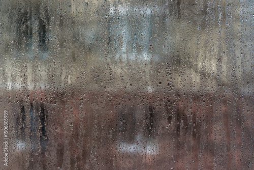 Slow-growing condensation droplets pattern interior glass like morning dew. abstract with glass background. fogged window inside apartment, increased humidity and cold form condensation on window