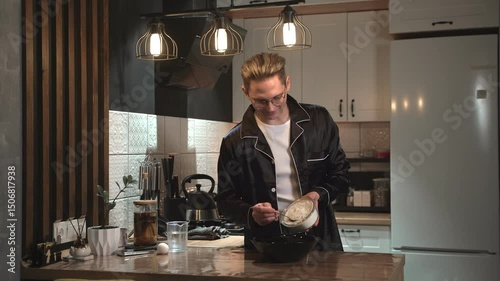 The Cooking Process in a Contemporary Kitchen Featuring a Stylish and Skilled Cook