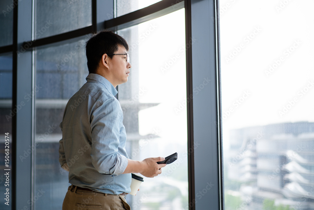 Fototapeta premium asian businessman using smart phone in office