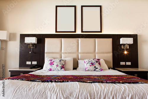 A modern hotel room featuring a family bed, complete with pillows and blankets.Ideal for concepts related to family vacations, hotel accommodations, and hospitality services. photo