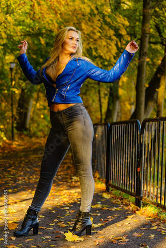Fashion woman walking in autumn park