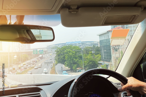 Image from inside of the car show traffic outdoor on suburb area of Bangkok, Thailand in the afternoon. Image use for transportation industry and holiday travel promotion background.
