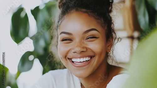 Happy woman smiling outdoors, greenery background, beauty portrait