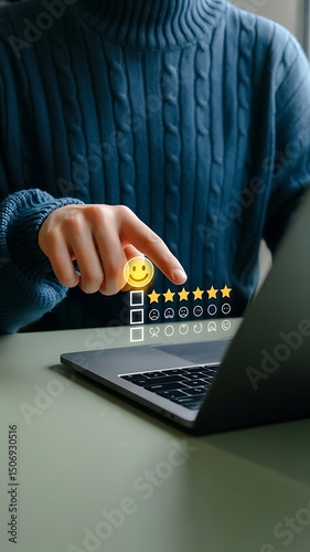 Person submitting excellent customer feedback on a laptop computer using smiley face rating