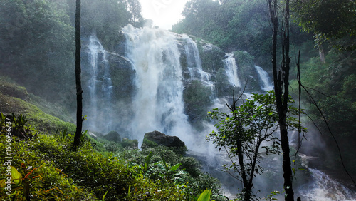 The nature of the waterfall in the forest that flows strongly during the rainy season. Strong current in the river, waters turned muddy after heavy rains in autumn.