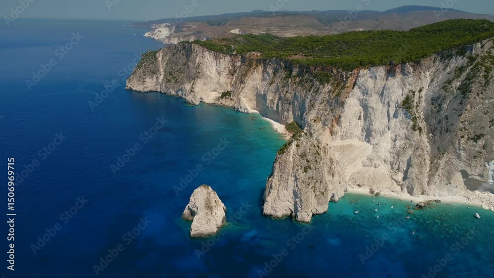 White rock near Keri blue lagoon with tourist pleasure boats. Top view Zakynthos island, Greece Called also Zante White rock near Keri blue lagoon with tourist pleasure boats. Top view Zakynthos island, Greece Called also Zante