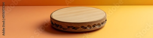 Handcrafted ash tambourine placed on a warm gradient of pale orange and yellow