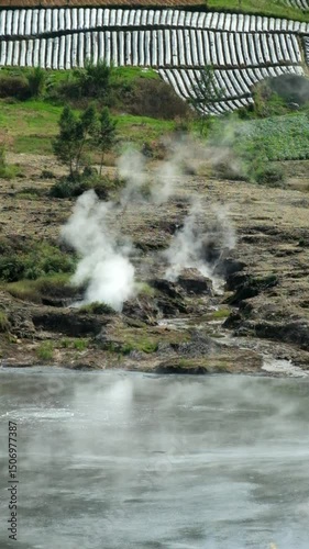 Vertical video Geothermal steam from an active crater.Active crater in the middle of a field in the mountains. Sileri Crater, Banjarnegara, Central Java, Indonesia.Concept of volcanoes.4K Fotage photo