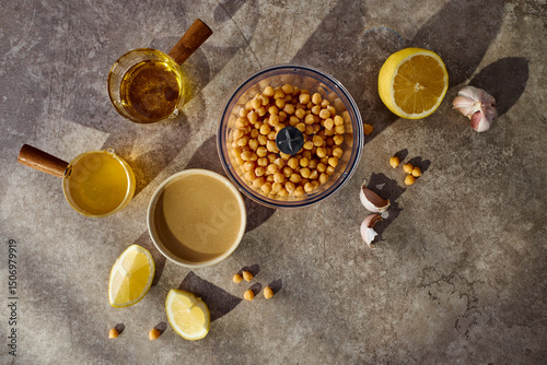 Chickpeas, lemon, tahini and herbs, ingredients for making hummus. Top view.