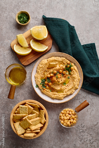 Delicious hummus with olive oil, chickpeas and parsley. Top view.
